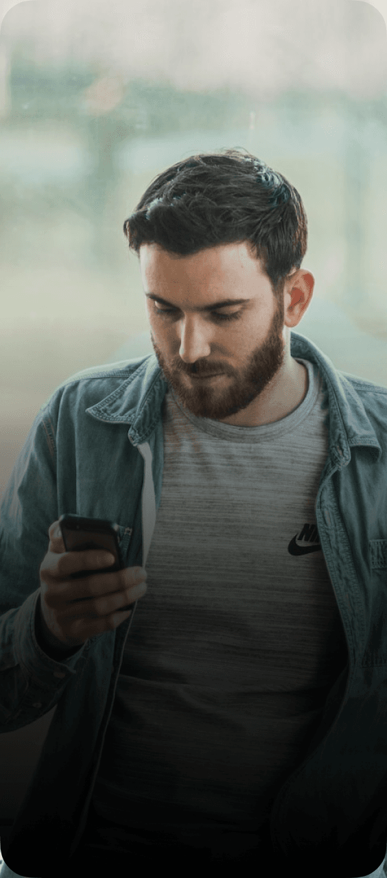 A man browsing his phone for car transport services