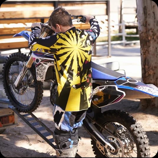 A man loading motorcycle into carrier