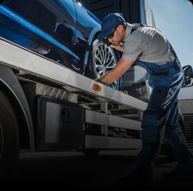 Men getting car ready to be shipped