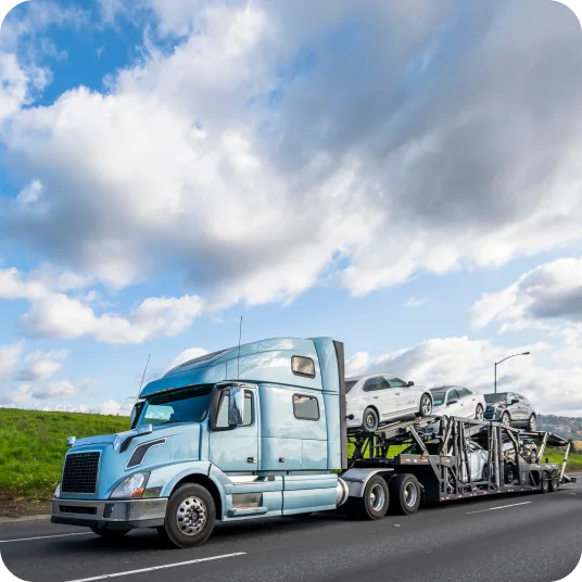 A Five-Car Hauler with cars on the road