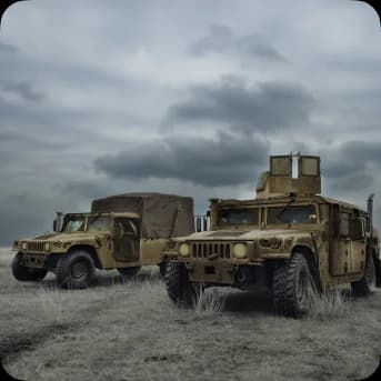 Two military vehicles parked