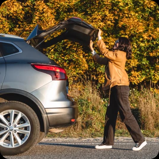 Woman closing backdoor of car