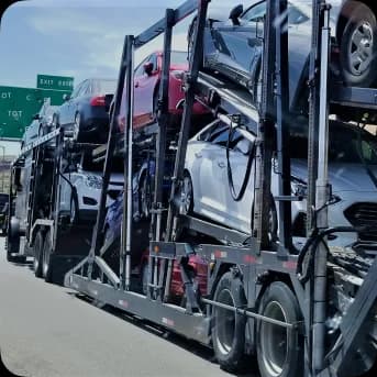 A double storied carrier with cars being transported