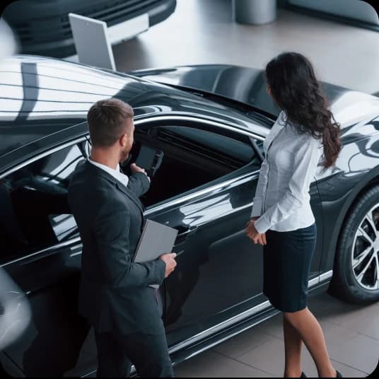 Female customer reviewing the car at dealership