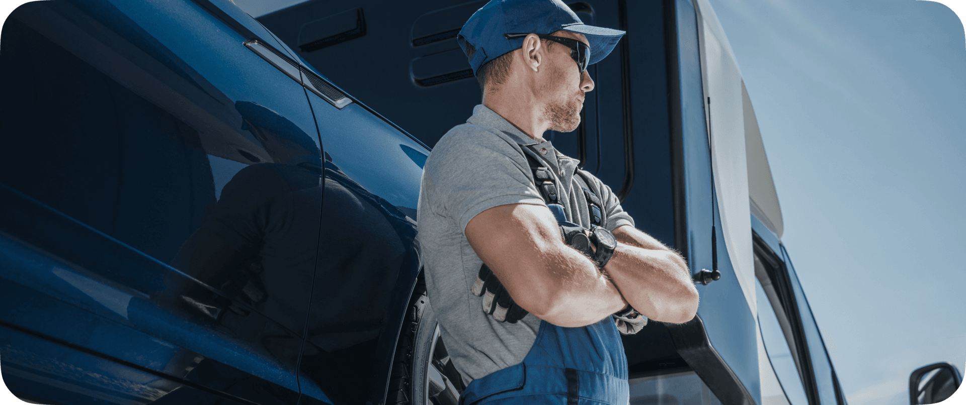 mechanic standing in front of a car hauler