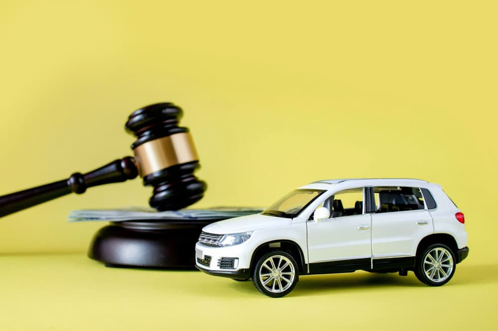 Image related to blog title Model car with a gavel and cash in the background, symbolizing auto transport bidding and decisions.
